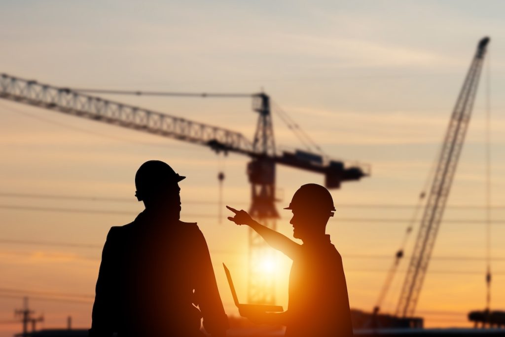 Silhouette,Of,Engineer,And,Foreman,Worker,Checking,Project,At,Building
